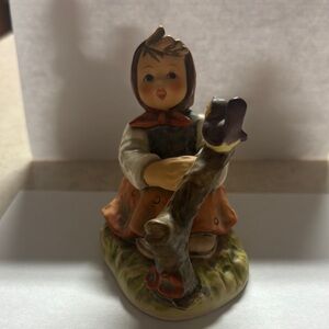 Charming Figurine with Orange and Brown Accents